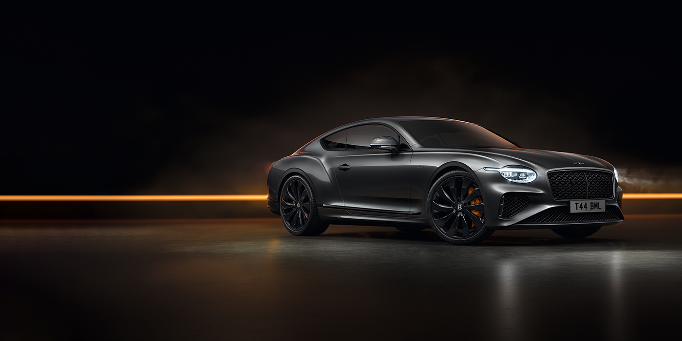 Bach Premium Cars GmbH Bentley Continental GT Black Edition coupe front three quarter in Anthracite black paint against a dark grey and copper background