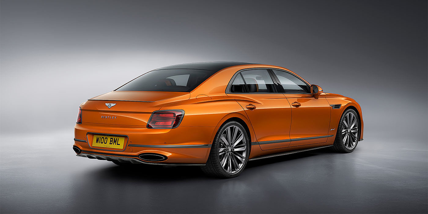 Bach Premium Cars GmbH Bentley Flying Spur Speed in Orange Flame colour rear view, featuring Bentley insignia and enhanced exhaust muffler.