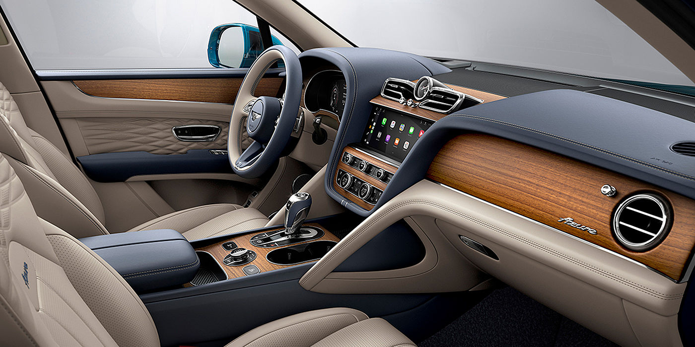 Bach Premium Cars GmbH  Bentley Bentayga Azure interior with Open Pore Koa veneer, view from the passenger seat over looking the driver's seat. 