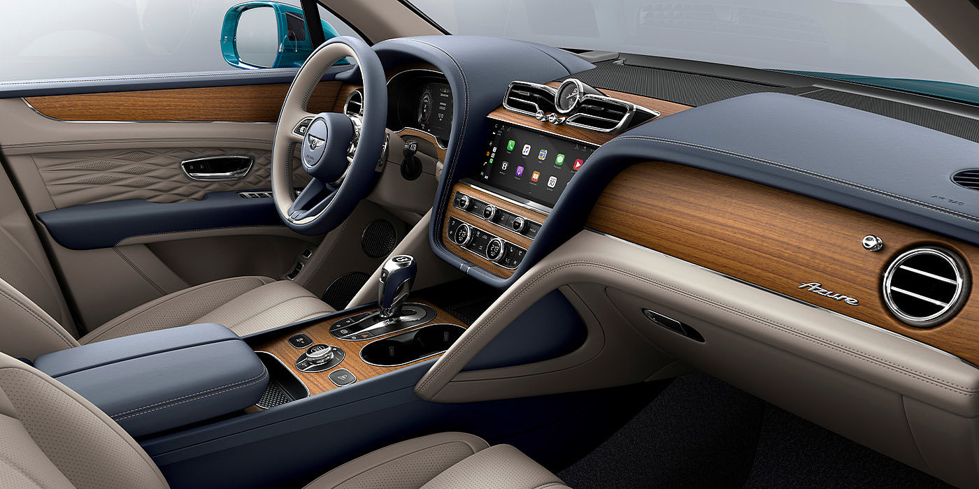 Bach Premium Cars GmbH Bentley Bentayga EWB Azure interior with Open Pore Koa veneer, view from the passenger seat over looking the driver's seat. 