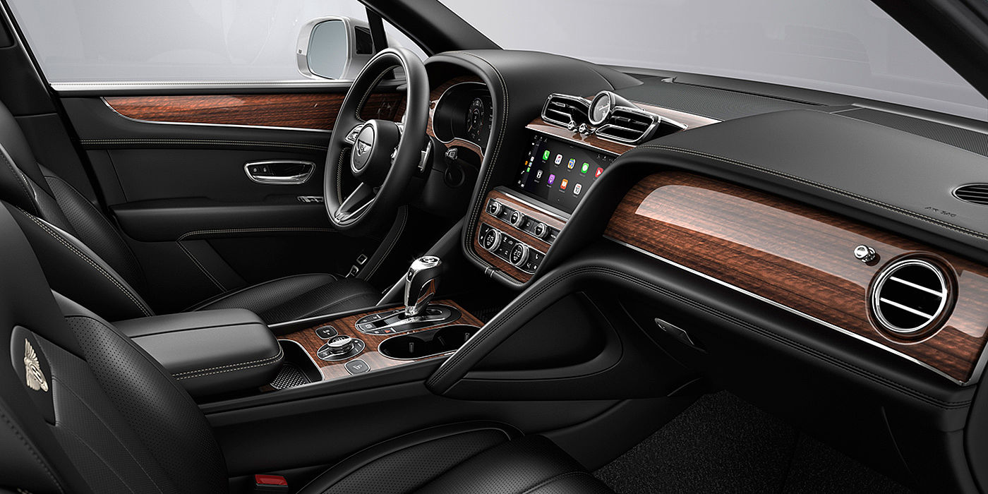 Bach Premium Cars GmbH Bentley Bentayga interior with a Crown Cut Walnut veneer, view from the passenger seat over looking the driver's seat.
