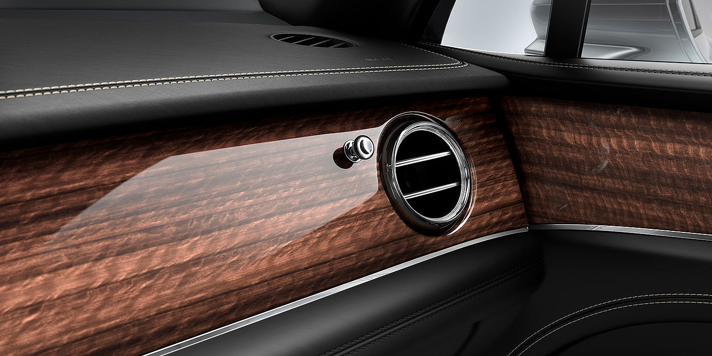 Bach Premium Cars GmbH Bentley Bentayga front interior Crown Cut Walnut veneer and chrome air vent.