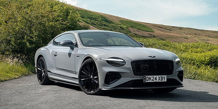 Bach Premium Cars GmbH Bentley Continental GT front three quarter with Carbon Fibre Specification parked on road.