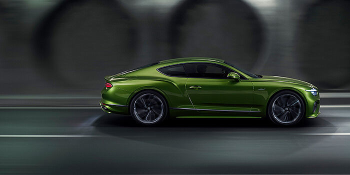  Bach Premium Cars GmbH Bentley Continental GT coupe in Tourmaline Green paint driving in profile on a dark road