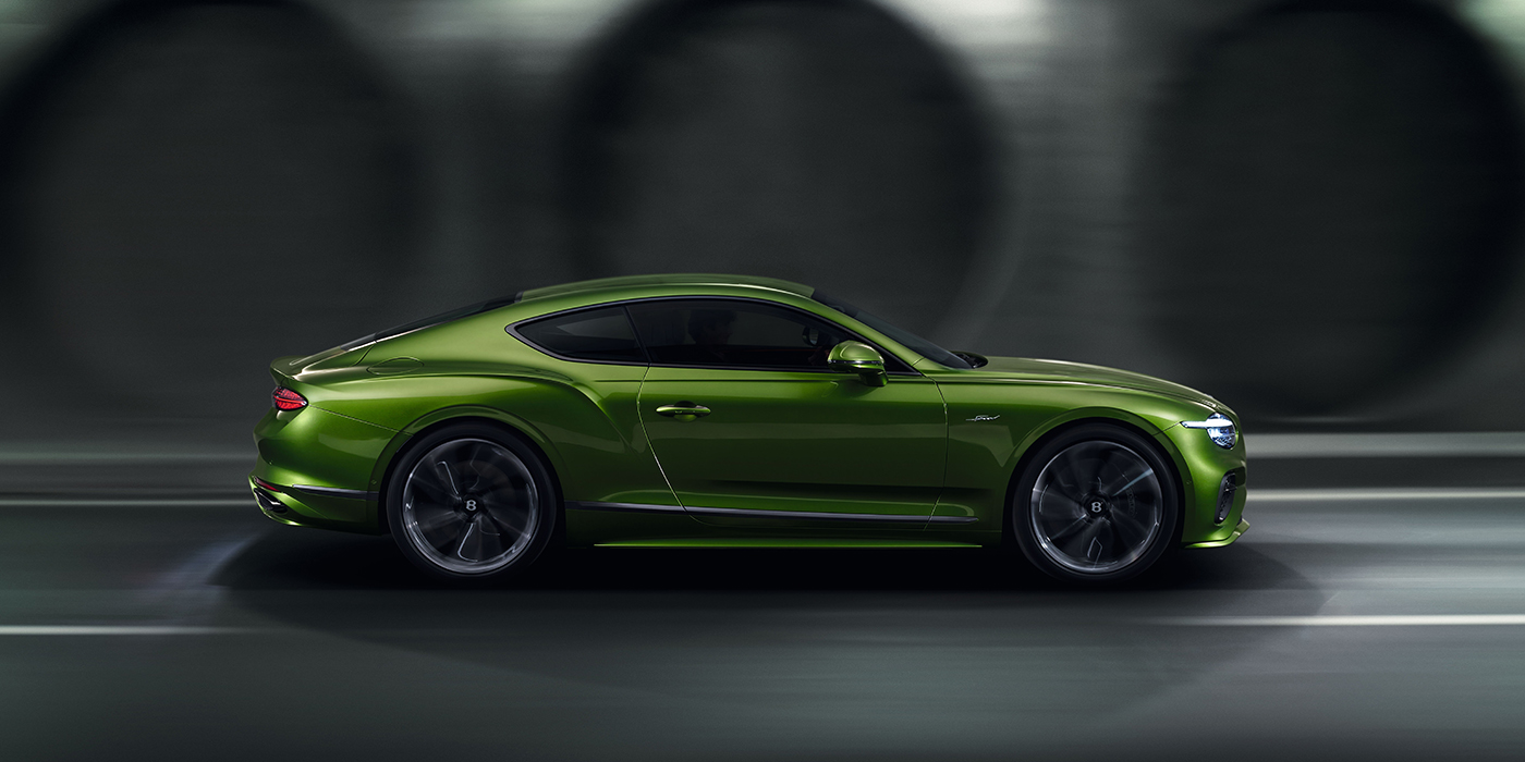 Bach Premium Cars GmbH Bentley Continental GT coupe in Tourmaline Green paint driving in profile on a dark road