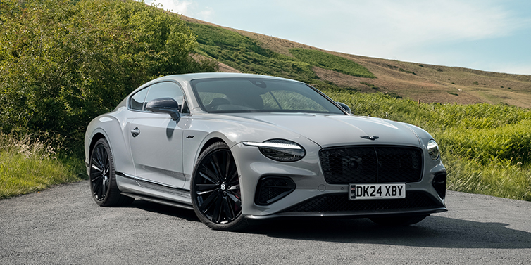 Bach Premium Cars GmbH Bentley Continental GT front three quarter with Carbon Fibre Specification parked on road.