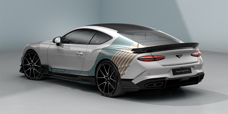 Bach Premium Cars GmbH Bentley Supersports rear three quarter in "Snowstorm" Design theme with Snow Quartz paint and Topaz blue and Camel brown paint stripes across the rear haunch.
