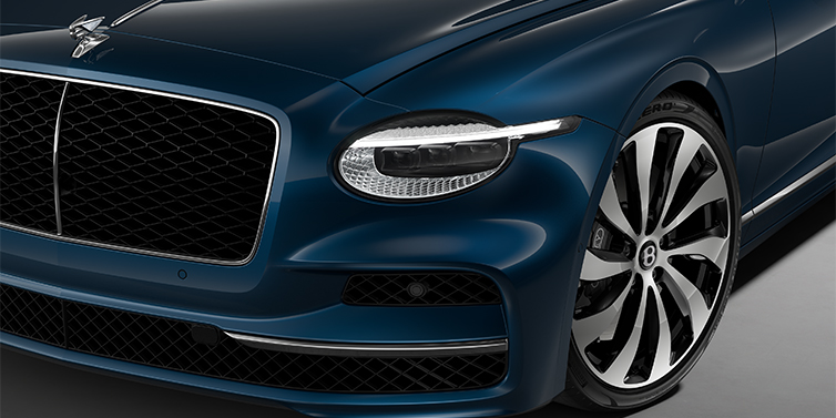 Bach Premium Cars GmbH New Bentley Flying Spur sedan head lamp against Marlin blue paint with 22" Ten Spoke Black Painted and Bright Machined wheel