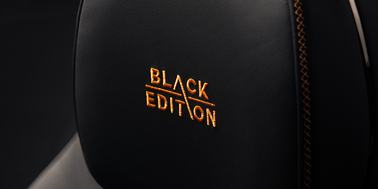 Bach Premium Cars GmbH Bentley Continental GT coupe seat headrest Black Edition stitched emblem in Mandarin colour against Beluga black hide