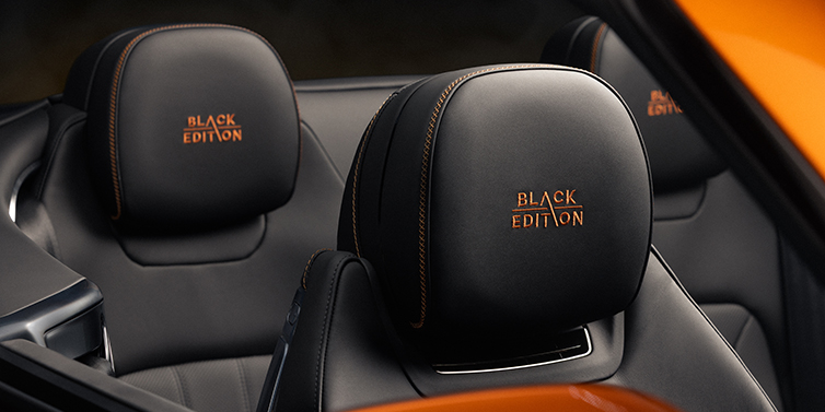 Bach Premium Cars GmbH Bentley Continental GTC Black Edition convertible seat detail with Beluga black hide and Mandarin emblem stitching