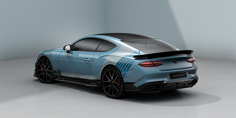 Bach Premium Cars GmbH Bentley Supersports rear three quarter in "Daybreak" Design theme with Jetstream blue paint and Arctica white and Portofino blue paint stripes across the rear haunch.